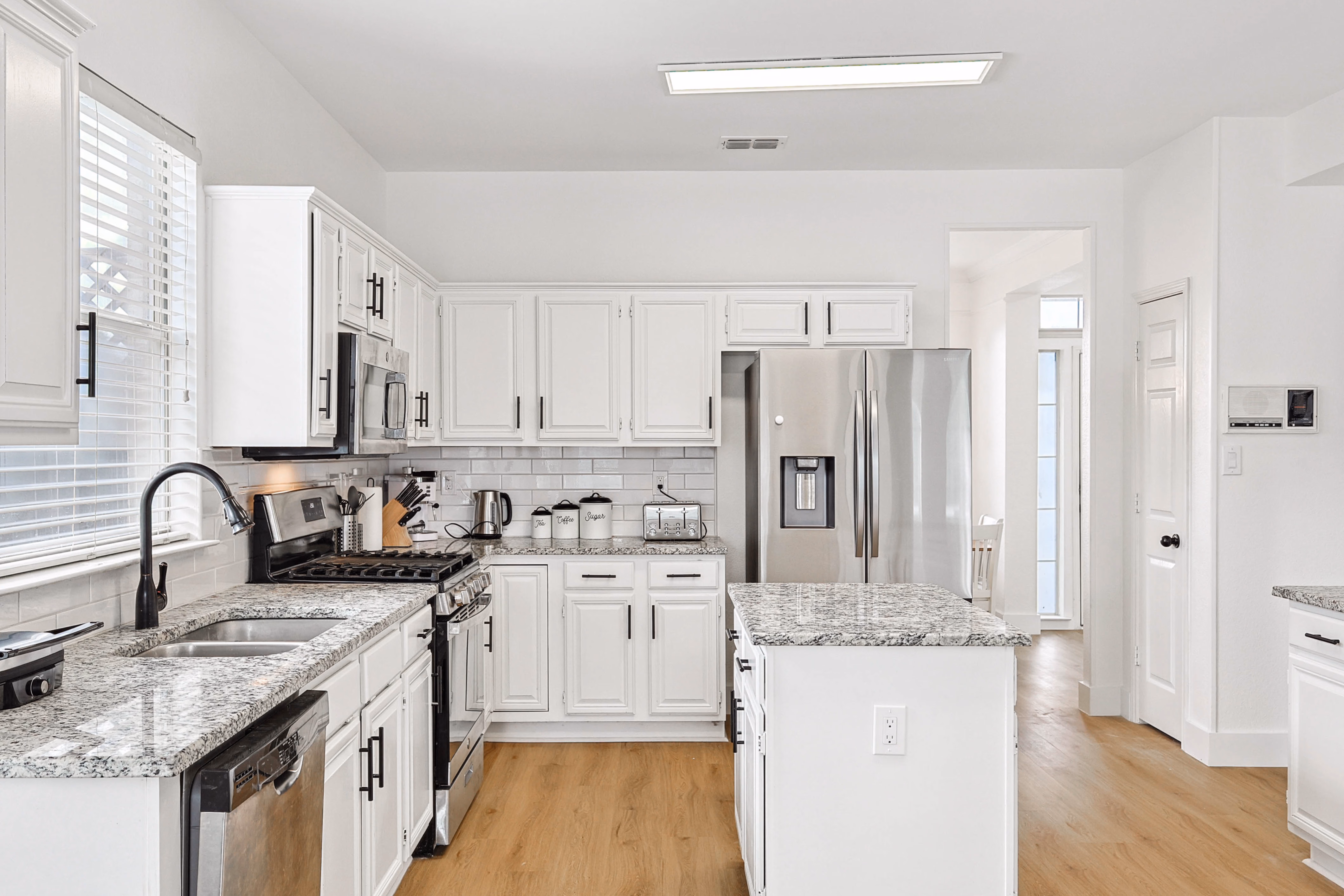 Kitchen — view down counter run with side door visible at far end.