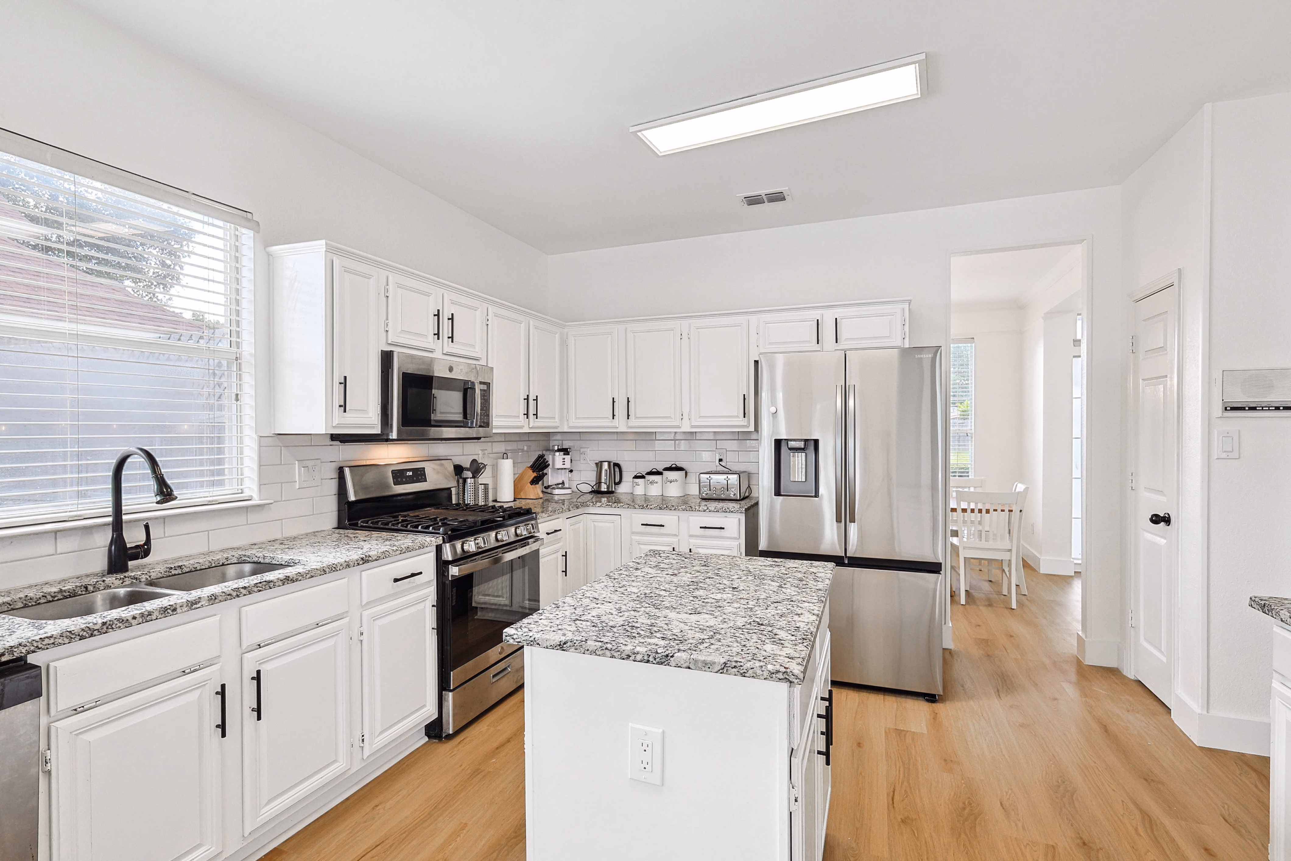 Kitchen — sink, gas range and microwave on the working wall.